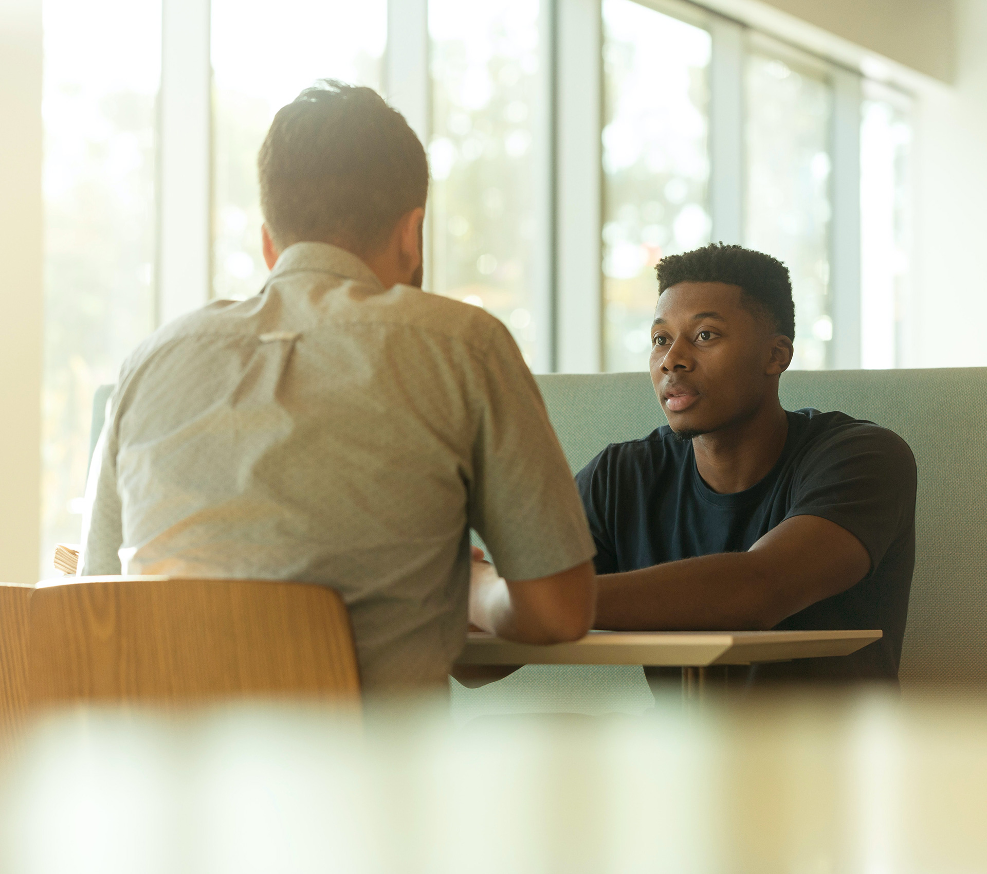 Young man interviewing at a coffee shop